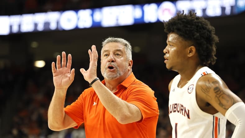Jan 22, 2022; Auburn, Alabama, USA;  Auburn Tigers head coach Bruce Pearl talks to guard Wendell Green Jr. (1) during a time out in the first half against the Kentucky Wildcats at Auburn Arena. Mandatory Credit: John Reed-USA TODAY Sports