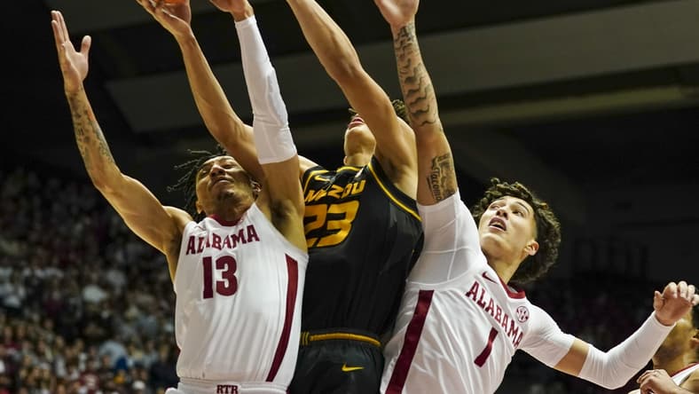 Jan 22, 2022; Tuscaloosa, Alabama, USA; Missouri Tigers forward Trevon Brazile (23) goes for the rebound along with Alabama Crimson Tide guard Jahvon Quinerly (13) and Alabama Crimson Tide guard Jusaun Holt (1) during the first half at Coleman Coliseum. Mandatory Credit: Marvin Gentry-USA TODAY Sports