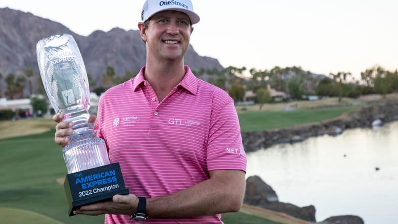 Hudson Swafford holds his trophy on the 18th green of the Pete Dye Stadium course after winning The American Express at PGA West in La Quinta, Calif., Sunday, Jan. 23, 2022.
