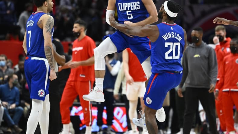 Jan 25, 2022; Washington, District of Columbia, USA; LA Clippers guard Luke Kennard (5) reacts after making a three-point basket while being fouled late in the fourth quarter against the Washington Wizards at Capital One Arena. Kennard would make the free-throw to take a one point lead with 1.9 seconds left in the game. Mandatory Credit: Brad Mills-USA TODAY Sports
