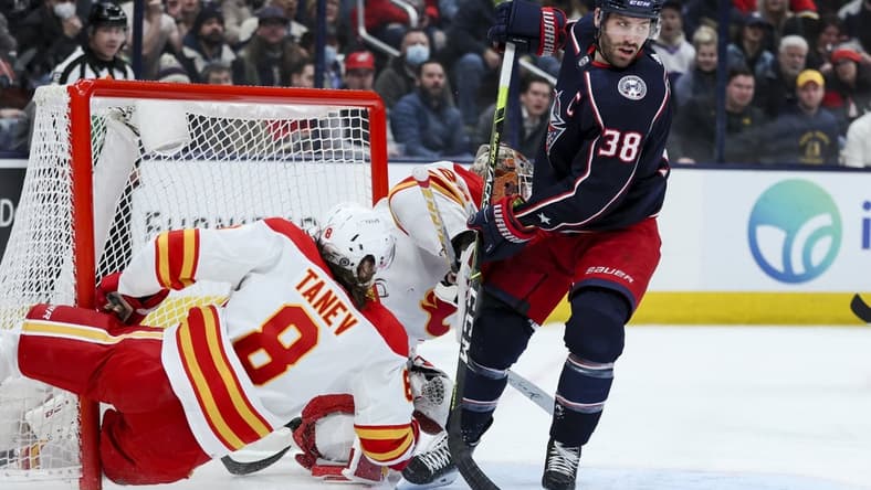 Jan 26, 2022; Columbus, Ohio, USA; Columbus Blue Jackets center Boone Jenner (38) skates as Calgary Flames defenseman Christopher Tanev (8) collides with the net in the second period at Nationwide Arena. Mandatory Credit: Aaron Doster-USA TODAY Sports