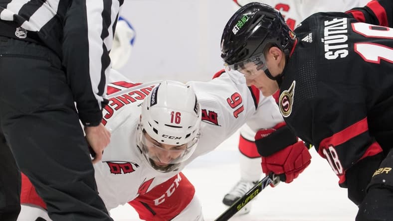 Jan 27, 2022; Ottawa, Ontario, CAN; Carolina Hurricanes cente Vincent Trocheck (16) faces off against Ottawa Senators left wing Tim St tzle (18) in the second period at the Canadian Tire Centre. Mandatory Credit: Marc DesRosiers-USA TODAY Sports