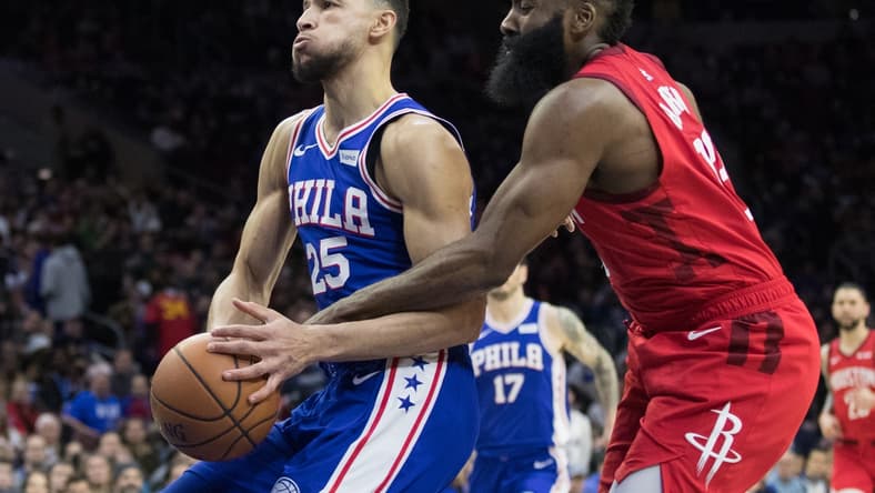 Jan 21, 2019; Philadelphia, PA, USA; Philadelphia 76ers guard Ben Simmons (25) is fouled by Houston Rockets guard James Harden (13) during the third quarter at Wells Fargo Center. Mandatory Credit: Bill Streicher-USA TODAY Sports