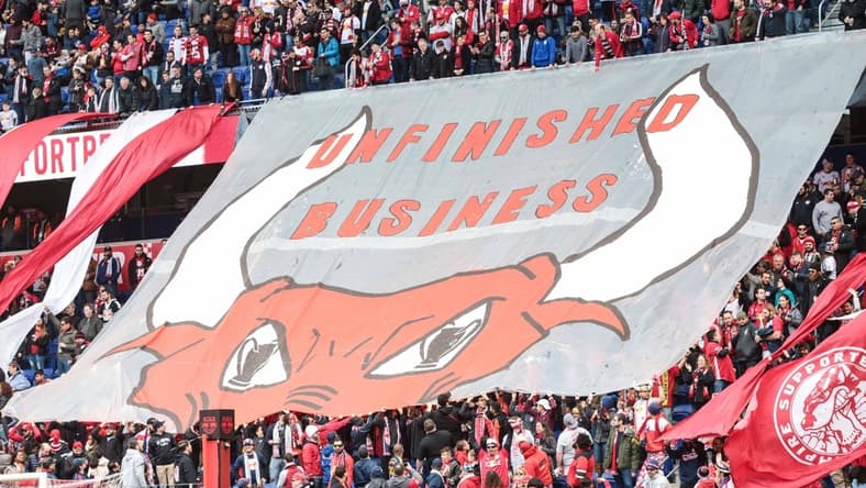 Mar 16, 2019; Harrison, NJ, USA; New York Red Bulls fans unveil a banner that reads "Unfinished Business"  before the game against the San Jose Earthquakes at Red Bull Arena. Mandatory Credit: Vincent Carchietta-USA TODAY Sports