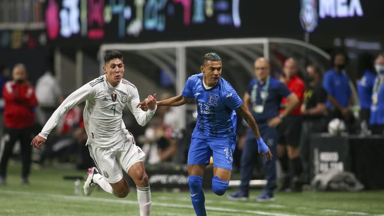 Jun 12, 2021; Atlanta, Georgia, USA; Mexico midfielder Edson Alvarez (4) and Honduras midfielder Kervin Arriaga (13) pursue a ball in the second half at Mercedes-Benz Stadium. Mandatory Credit: Brett Davis-USA TODAY Sports