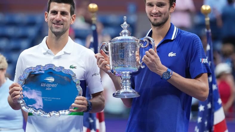 Sep 12, 2021; Flushing, NY, USA; (L-R) Novak Djokovic of Serbia and Daniil Medvedev of Russia celebrate with the finalist and championship trophies, respectively, after their match in the men's singles final on day fourteen of the 2021 U.S. Open tennis tournament at USTA Billie Jean King National Tennis Center. Mandatory Credit: Danielle Parhizkaran-USA TODAY Sports