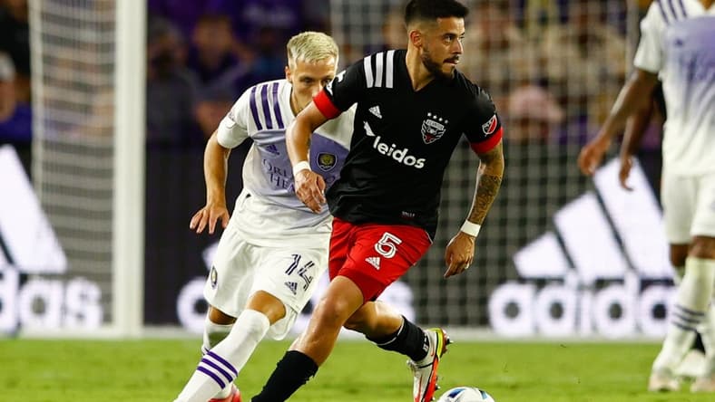 Oct 2, 2021; Orlando, Florida, USA; D.C. United midfielder Junior Moreno (5) controls the ball past Orlando City forward Silvester van der Water (14) in the second half at Orlando City Stadium. Mandatory Credit: Nathan Ray Seebeck-USA TODAY Sports