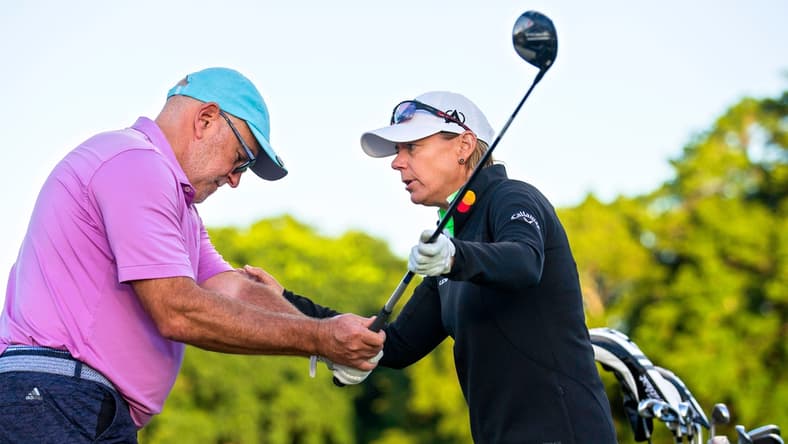 Annika Sorenstam helps Steven Collis with his game during a charity golf clinic presented by Jack Nicklaus, Sorenstam and Ernie Els at PGA National in Palm Beach Gardens Monday, October 4, 2021.