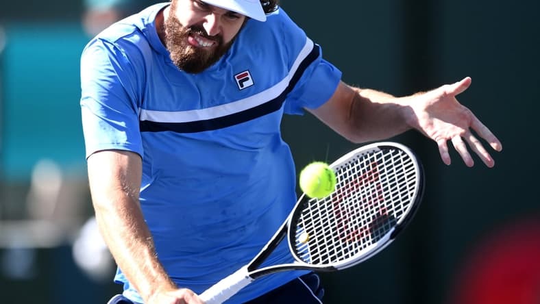 Oct 11, 2021; Indian Wells, CA, USA; Reilly Opelka (USA) hits a shot against Grigor Dimitrov (BUL) during his third round match in the BNP Paribas Open at the Indian Wells Tennis Garden. Mandatory Credit: Jayne Kamin-Oncea-USA TODAY Sports