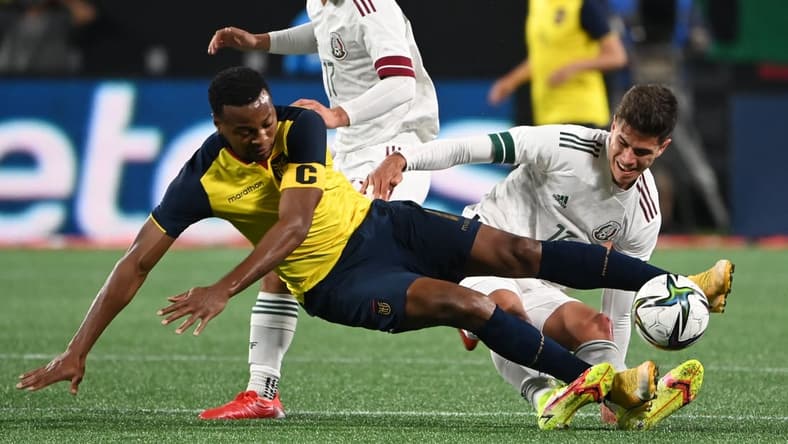 Oct 27, 2021; Charlotte, North Carolina, USA;  Ecuador forward Michael Estrada (11) and Mexico defender Haret Ortaga (13) fight for the ball in the second half at Bank of America Stadium. Mandatory Credit: Bob Donnan-USA TODAY Sports