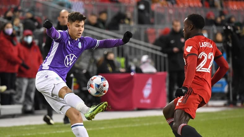 Nov 3, 2021; Toronto, Ontario, Canada; Pacific FC defender Kadin Chung (2) controls the ball in front of Toronto FC defender Richie Laryea (22) in the first half of a the Canadian Championship semi-final at BMO Field. Mandatory Credit: Dan Hamilton-USA TODAY Sports