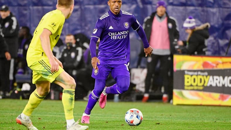 Nov 23, 2021; Nashville, TN, USA; Orlando City forward Benji Michel (19) dribbles the ball around Nashville SC defender Alistair Johnston (12) during the second half of a round one MLS Playoff game at Nissan Stadium. Mandatory Credit: Steve Roberts-USA TODAY Sports