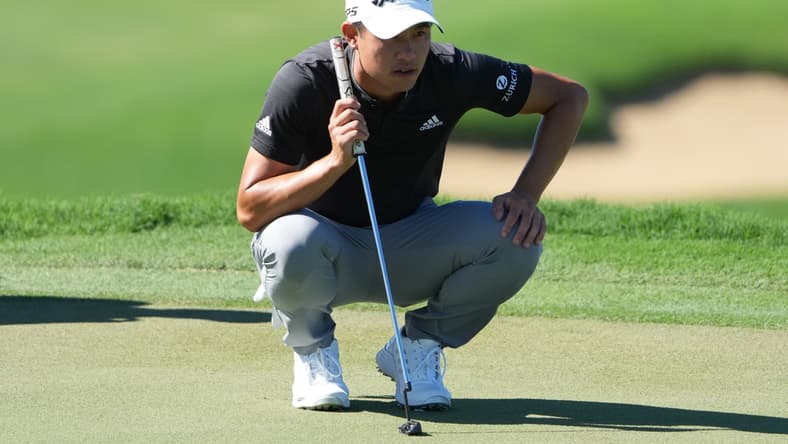 January 8, 2022; Maui, Hawaii, USA; Collin Morikawa lines up his putt on the 13th hole during the third round of the Sentry Tournament of Champions golf tournament at Kapalua Resort - The Plantation Course. Mandatory Credit: Kyle Terada-USA TODAY Sports