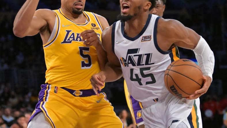 Jan 17, 2022; Los Angeles, California, USA; Los Angeles Lakers guard Talen Horton-Tucker (5) defends Utah Jazz guard Donovan Mitchell (45) in the second half at Crypto.com Arena. Mandatory Credit: Jayne Kamin-Oncea-USA TODAY Sports
