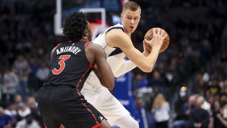Jan 19, 2022; Dallas, Texas, USA;  Dallas Mavericks center Kristaps Porzingis (6) controls the ball as Toronto Raptors forward OG Anunoby (3) defends during the first quarter at American Airlines Center. Mandatory Credit: Kevin Jairaj-USA TODAY Sports