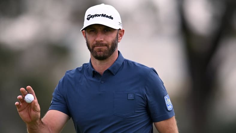 Jan 29, 2022; San Diego, California, USA; Dustin Johnson acknowledges the crowd after a putt on the first green during the final round of the Farmers Insurance Open golf tournament at Torrey Pines Municipal Golf Course - South Course. Mandatory Credit: Orlando Ramirez-USA TODAY Sports