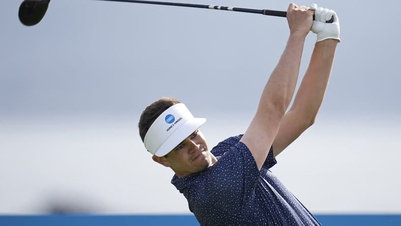 Feb 5, 2022; Pebble Beach, California, USA; Beau Hossler plays his shot on the 18th tee during the third round of the AT&T Pebble Beach Pro-Am golf tournament at Pebble Beach Golf Links. Mandatory Credit: Ray Acevedo-USA TODAY Sports