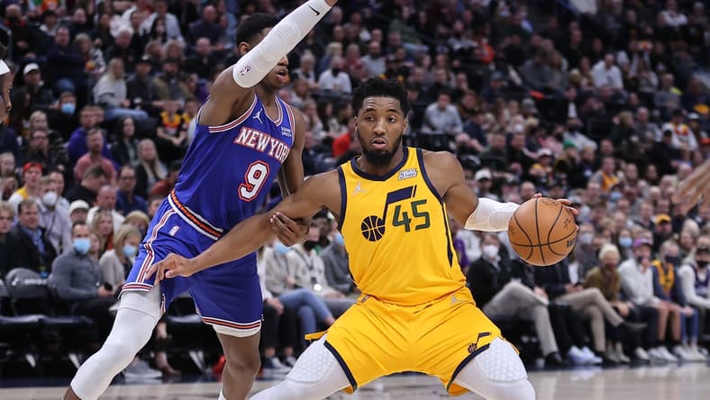 Feb 7, 2022; Salt Lake City, Utah, USA; Utah Jazz guard Donovan Mitchell (45) steps back to take a shot defended by New York Knicks guard RJ Barrett (9) in the third quarter at Vivint Arena. Mandatory Credit: Rob Gray-USA TODAY Sports