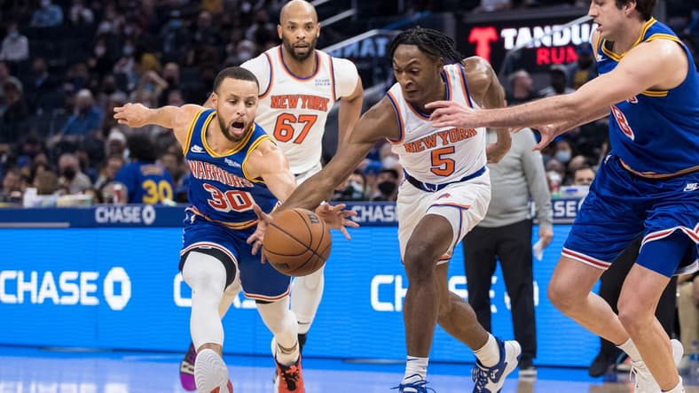 Feb 10, 2022; San Francisco, California, USA; Golden State Warriors guard Stephen Curry (30) and New York Knicks guard Immanuel Quickley (5) scramble for possession during the first half at Chase Center. Mandatory Credit: John Hefti-USA TODAY Sports