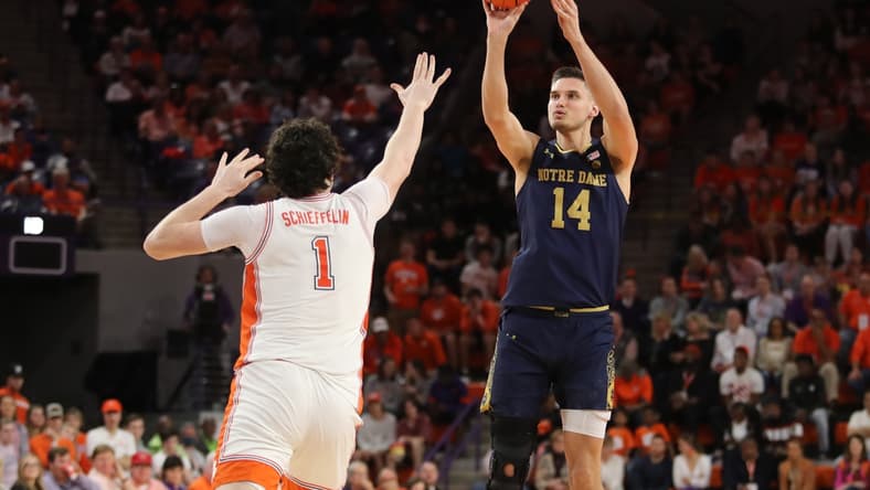 Feb 12, 2022; Clemson, South Carolina, USA; Notre Dame Fighting Irish forward Nate Laszewski (14) shoots the ball against Clemson Tigers forward Ian Schieffelin (1) during the first half at Littlejohn Coliseum. Mandatory Credit: Dawson Powers-USA TODAY Sports