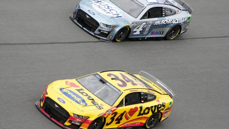 Feb 15, 2022; Daytona, FL, USA; NASCAR Cup Series driver Michael McDowell (34) and driver Kevin Harvick (4) during practice for the Daytona 500 at Daytona International Speedway. Mandatory Credit: Mike Dinovo-USA TODAY Sports