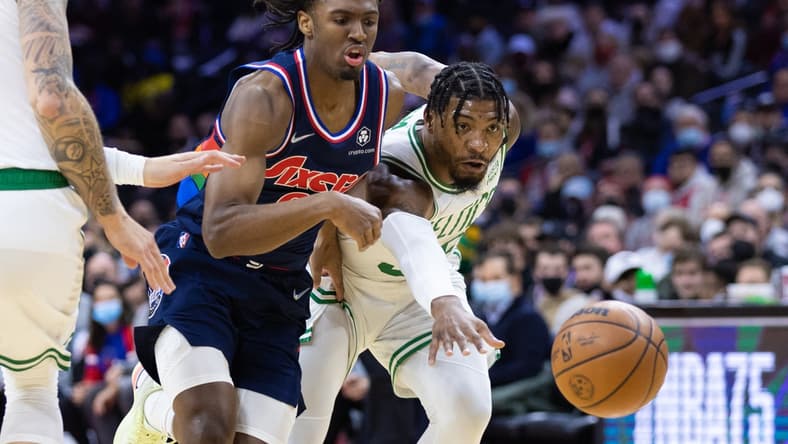 Feb 15, 2022; Philadelphia, Pennsylvania, USA; Philadelphia 76ers guard Tyrese Maxey (0) and Boston Celtics guard Marcus Smart (36) chase a loose ball during the first quarter at Wells Fargo Center. Mandatory Credit: Bill Streicher-USA TODAY Sports