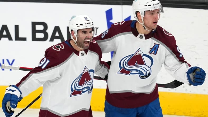 Feb 16, 2022; Las Vegas, Nevada, USA; Colorado Avalanche right wing Mikko Rantanen (96) celebrates with center Nazem Kadri (91) after scoring a power-play goal against the Vegas Golden Knights during the third period at T-Mobile Arena. Mandatory Credit: Stephen R. Sylvanie-USA TODAY Sports