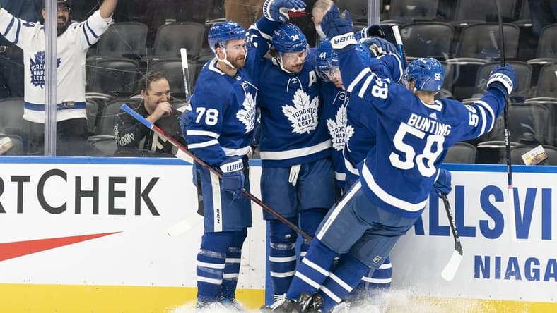 Feb 17, 2022; Toronto, Ontario, CAN; Toronto Maple Leafs center Auston Matthews (34) celebrates scoring a goal with Toronto Maple Leafs left wing Michael Bunting (58) during the first period against the Pittsburgh Penguins at Scotiabank Arena. Mandatory Credit: Nick Turchiaro-USA TODAY Sports