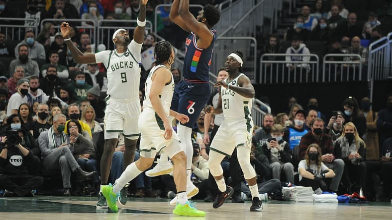 Feb 17, 2022; Milwaukee, Wisconsin, USA; Philadelphia 76ers center Joel Embiid (21) puts up a shot against Milwaukee Bucks center Bobby Portis (9) in the first quarter at Fiserv Forum. Mandatory Credit: Michael McLoone-USA TODAY Sports