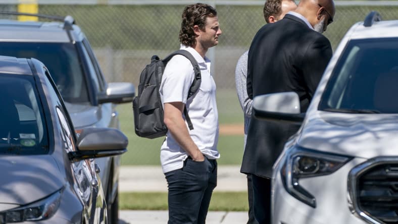 Feb 23, 2022; Jupiter, FL, USA;  New York Yankees pitcher Gerrit Cole, center, arrives for MLB contract negotiations at Roger Dean Stadium in Jupiter, Florida on February 23, 2022.   Mandatory Credit: Greg Lovett-USA TODAY NETWORK