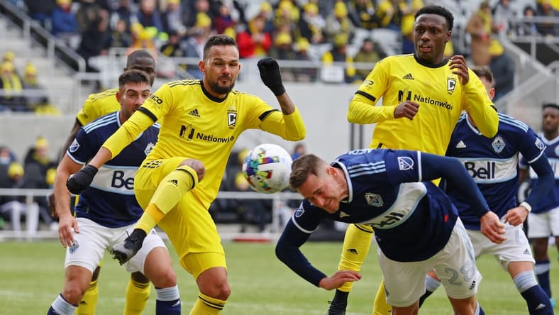Feb 26, 2022; Columbus, OH, USA; Columbus Crew midfielder Artur (8) and Vancouver Whitecaps defender Jake Nerwinski (28) make a play for the ball during the first half at Lower.com Field. Mandatory Credit: Trevor Ruszkowski-USA TODAY Sports