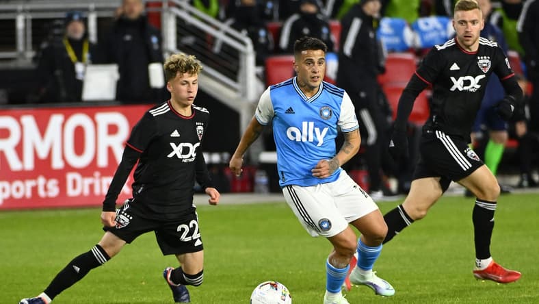 Feb 26, 2022; Washington, District of Columbia, USA; Charlotte FC forward Christian Ortiz (10) and D.C. United forward Griffin Yow (22) battle for the ball in the first half at Audi Field. Mandatory Credit: Brad Mills-USA TODAY Sports