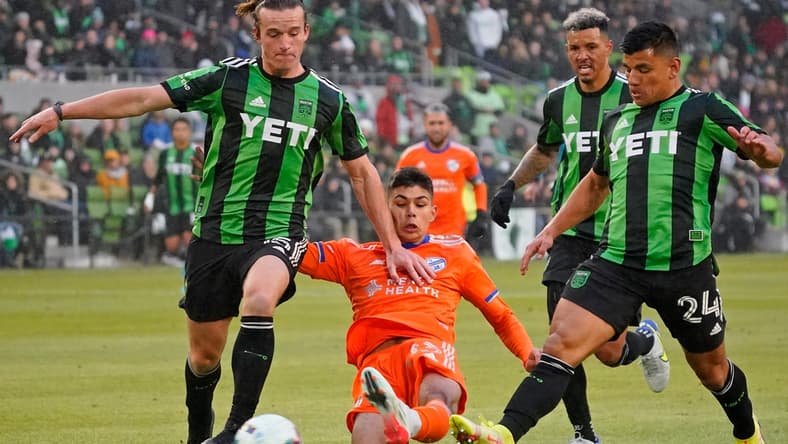 Feb 26, 2022; Austin, Texas, USA; FC Cincinnati forward Nicholas Markanich (33) reaches for the ball between Austin FC midfielder Kipp Keller (left) and Austin FC defender Zan Kolmanic (right) during the first half at Q2 Stadium. Mandatory Credit: Scott Wachter-USA TODAY Sports