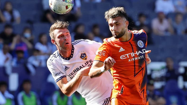 Feb 27, 2022; Carson, California, USA; Los Angeles Galaxy forward Nick DePuy (20) and New York City midfielder Valent n Castellanos (11) battle for the ball during the first half at Dignity Health Sports Park. Mandatory Credit: Kiyoshi Mio-USA TODAY Sports