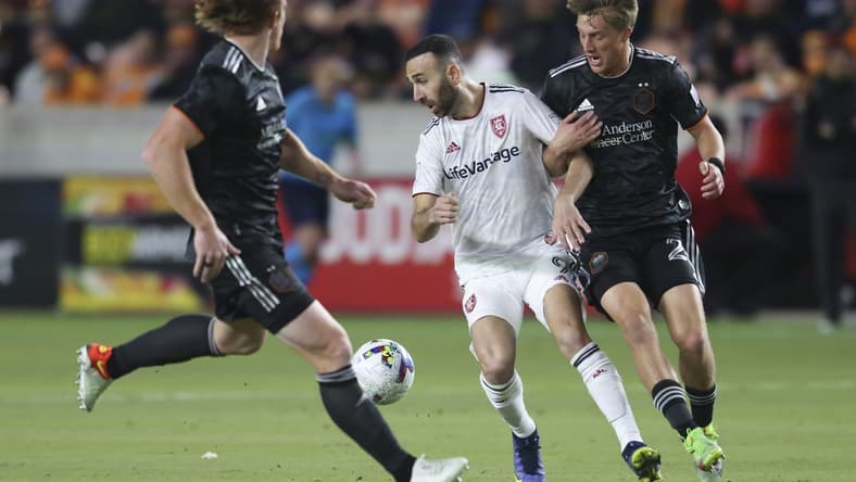 Feb 27, 2022; Houston, Texas, USA;  Real Salt Lake midfielder Justin Meram (9) and Houston Dynamo FC defender Daniel Steres (2) fight over the ball in the first half at PNC Stadium. Mandatory Credit: Thomas Shea-USA TODAY Sports