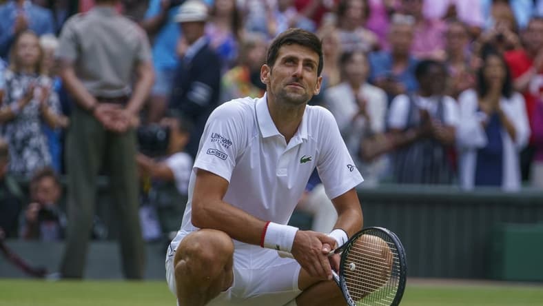Jul 14, 2019; London, United Kingdom; Novak Djokovic (SRB) celebrates after match point against Roger Federer (SUI) during the mens final match on day 13 at the All England Lawn and Croquet Club. Mandatory Credit: Susan Mullane-USA TODAY Sports