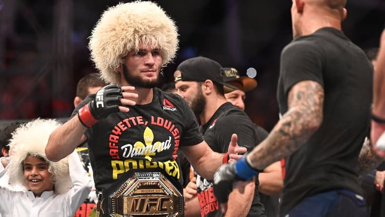 Sep 7, 2019; Abu Dhabi, UAE; Khabib Nurmagomedov (red gloves) greets Dustin Poirier (blue gloves) during UFC 242 at The Arena. Mandatory Credit: Per Haljestam-USA TODAY Sports