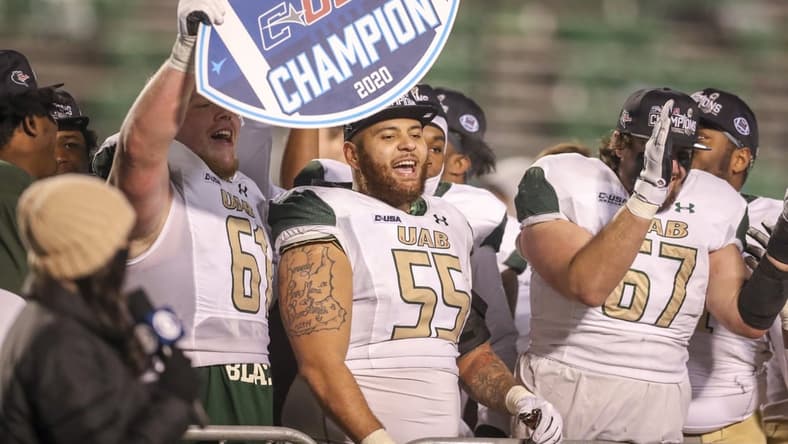 Dec 18, 2020; Huntington, West Virginia, USA; UAB Blazers players celebrate after defeating the Marshall Thundering Herd for the Conference USA Championship at Joan C. Edwards Stadium. Mandatory Credit: Ben Queen-USA TODAY Sports