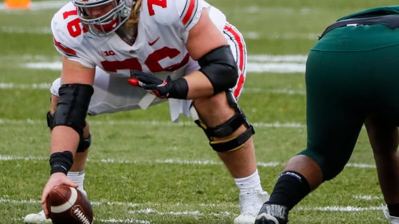 Ohio State Buckeyes offensive lineman Harry Miller (76) prepares to snap the ball during the first quarter of a NCAA Division I football game between the Michigan State Spartans and the Ohio State Buckeyes on Saturday, Dec. 5, 2020 at Spartan Stadium in East Lansing, Michigan.
Cfb Ohio State Buckeyes At Michigan State Spartans