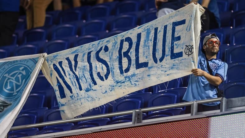 Aug 21, 2021; Harrison, New Jersey, USA; A fan displays a banner during a weather delay before a match between the New York Red Bulls and New York City FC at Red Bull Arena. Mandatory Credit: Vincent Carchietta-USA TODAY Sports
