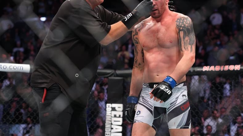 Nov 6, 2021; New York, NY, USA; Colby Covington (blue gloves) gets cleaned up during his fight against Kamaru Usman (red gloves) during UFC 268 at Madison Square Garden. Mandatory Credit: Ed Mulholland-USA TODAY Sports