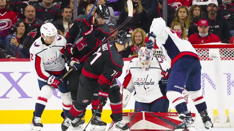 Nov 28, 2021; Raleigh, North Carolina, USA; Washington Capitals goaltender Ilya Samsonov (30) stops Carolina Hurricanes right wing Jesper Fast (71) and center Jordan Staal (11) during the third period at PNC Arena. Mandatory Credit: James Guillory-USA TODAY Sports