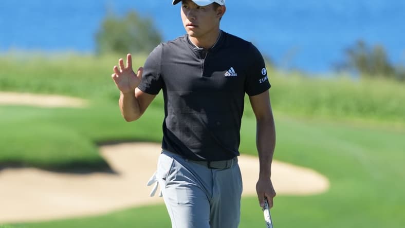 January 8, 2022; Maui, Hawaii, USA; Collin Morikawa acknowledges the crowd after making his putt on the 13th hole during the third round of the Sentry Tournament of Champions golf tournament at Kapalua Resort - The Plantation Course. Mandatory Credit: Kyle Terada-USA TODAY Sports