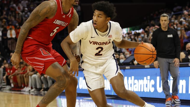 Jan 24, 2022; Charlottesville, Virginia, USA; Virginia Cavaliers guard Reece Beekman (2) drives to the basket as Louisville Cardinals forward Malik Williams (5) defends during the second half at John Paul Jones Arena. Mandatory Credit: Geoff Burke-USA TODAY Sports