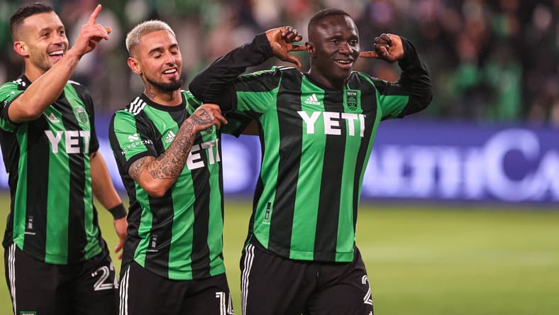 Feb 26, 2022; Austin, TX, USA; Austin FC forward Moussa Djitte (2) celebrates with midfielder Diego Fagundez (14) and midfielder Felipe Martins (22) after scoring Austin FC's fifth and final goal against FC Cincinnati at Q2 Stadium. Mandatory Credit: Aaron Martinez/American-Statesman via USA TODAY NETWORK