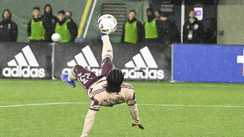 Feb 26, 2022; Portland, Oregon, USA; Portland Timbers forward Yimmi Chara (23) scores a goal off a bicycle kick during the second half against the New England Revolution at Providence Park. The game ended in a tie 2-2. Mandatory Credit: Troy Wayrynen-USA TODAY Sports