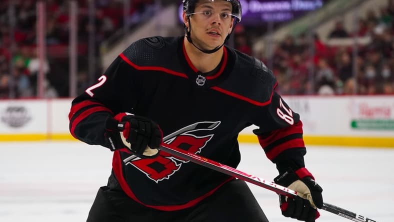 Feb 25, 2022; Raleigh, North Carolina, USA; Carolina Hurricanes center Jesperi Kotkaniemi (82) watches the play against the Columbus Blue Jackets during the third period at PNC Arena. Mandatory Credit: James Guillory-USA TODAY Sports