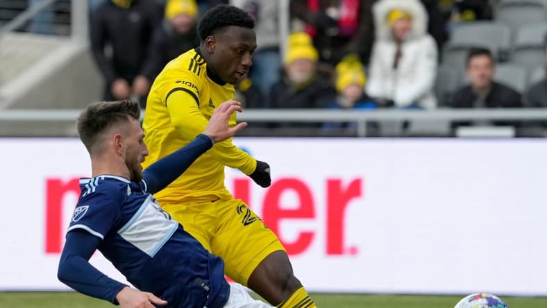Vancouver Whitecaps defender Tristan Blackmon (6) slides in on Columbus Crew midfielder Derrick Etienne (22) during the second half of Saturday's season opener at Lower.com field in Columbus, Oh., on February 26, 2022.

Ceb Crew 0227 Bjp 30
