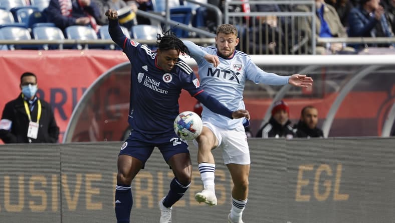 Mar 5, 2022; Foxborough, Massachusetts, USA; New England Revolution forward DeJuan Jones (24) battles FC Dallas forward Paul Arriola (7) for the ball during the first half at Gillette Stadium. Mandatory Credit: Winslow Townson-USA TODAY Sports