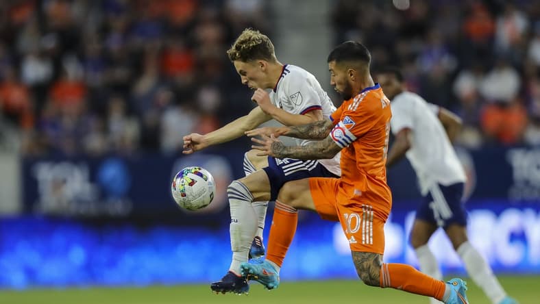 Mar 5, 2022; Cincinnati, OH, USA; D.C. United forward Griffin Yow (22) battles for the ball against FC Cincinnati midfielder Luciano Acosta (10) in the first half at TQL Stadium. Mandatory Credit: Katie Stratman-USA TODAY Sports
